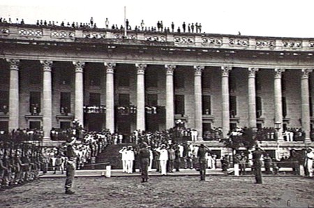 A VIEW OF THE FRONT OF THE MUNICIPAL BUILDING, SHOWING CROWDS LINING THE VERANDAHS AND WINDOW LEDGES